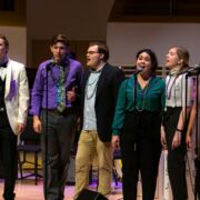 School of Music vocalists performing on stage during the Mardi Gras Jazz Concert at the Recital Hall.