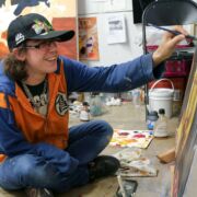 SoVA student painting in studio.