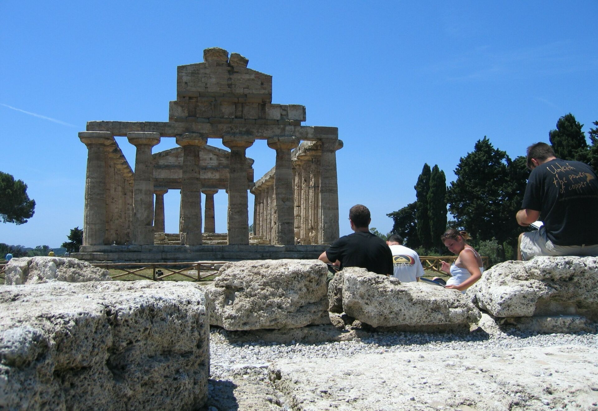 Students sitting at the ruins of Paestum, sketching the architecture.