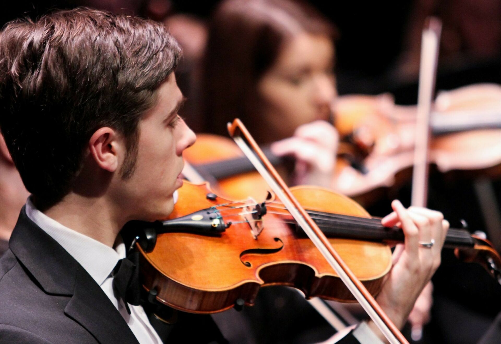 School of Music orchestra performance showcasing a violinist..