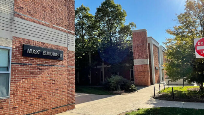 brick facades of music buildings with sidewalks, trees, and grass exterior