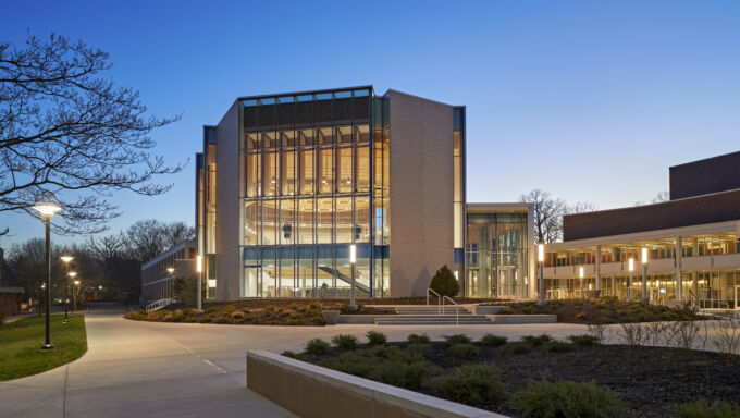 Ebser Recital Hall exterior at dusk, with warm light from windows.