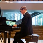 A piano performer is playing piano on the stage.