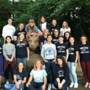 A group of Clarinet Studios's students are taking photo with Nittany Lion Statue