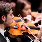 School of Music orchestra performance showcasing a violinist..