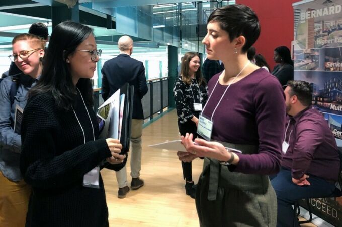 Students and professional firm representatives gathered and talking during Career Day, held in the glass, wood, and steel mezzanine area of the Stuckeman School.