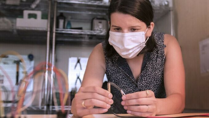 Elena Vazquez doing research in the Stuckeman Center for Design Computing in a face mask.