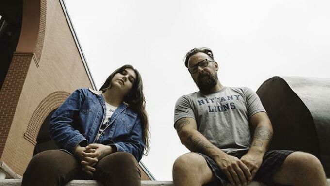 young woman and man pose on Penn State campus