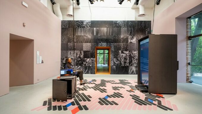 Felecia Davis sits in a hair salon chair in her display at the Venice Biennale.