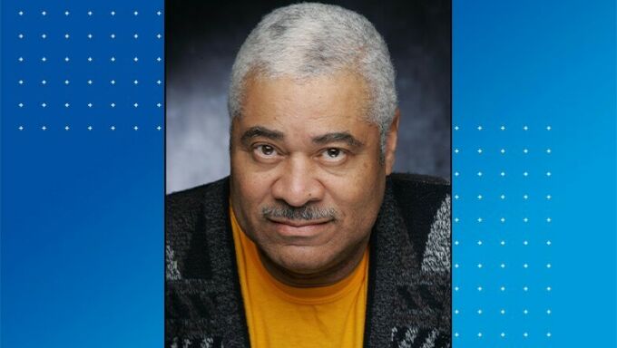 Head shot of an older black man with grey hair and moustache