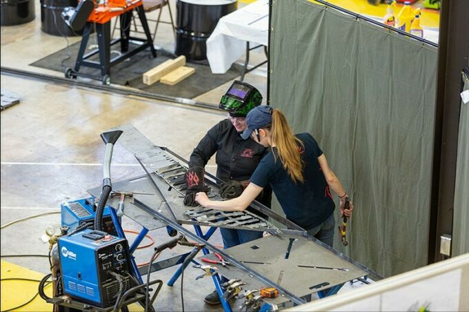 Lizz Andrzejewski, left, and Elizabeth Rothrock work on welding pieces of the chapel wall together in the Laundry Building.