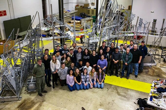 Members of the Penn State team and the Penn College team pose with the completed chapel in the Laundry Building.