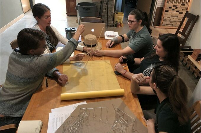 Gillean Denny meets with Becca Newburg, Kacie Ward, Elizabeth Andrzejewski and Elizabeth Rothrock to discuss design plans.