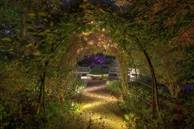 A lighted entry way to the Hintz Alumni Garden.