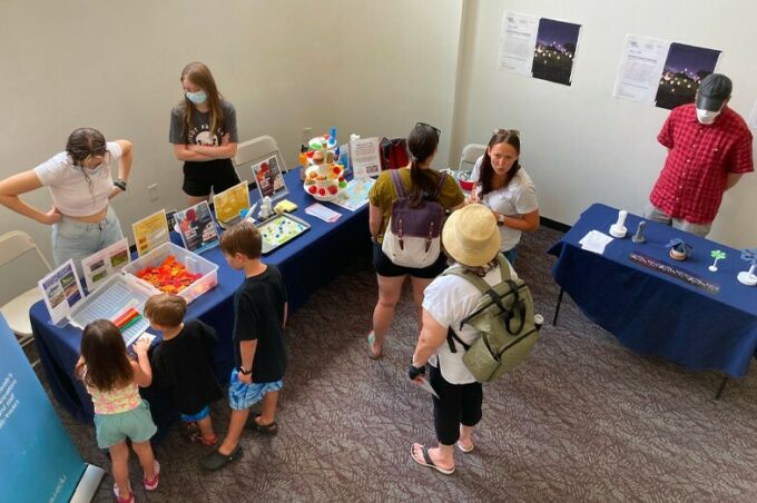 Families looking at the visual prototypes and participating in educational activities at the Woskob Family Gallery