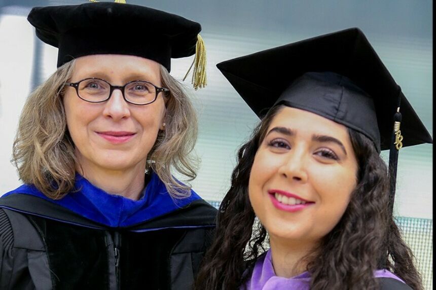 Poerschke, at left, with a student in graduation garb.