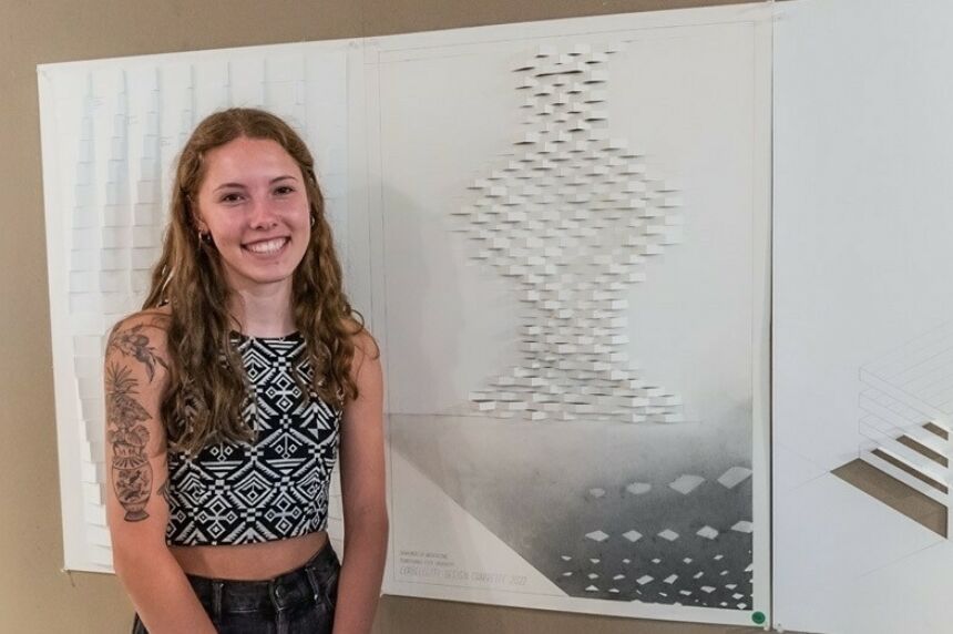 Sophie Marks stands next to her winning design.