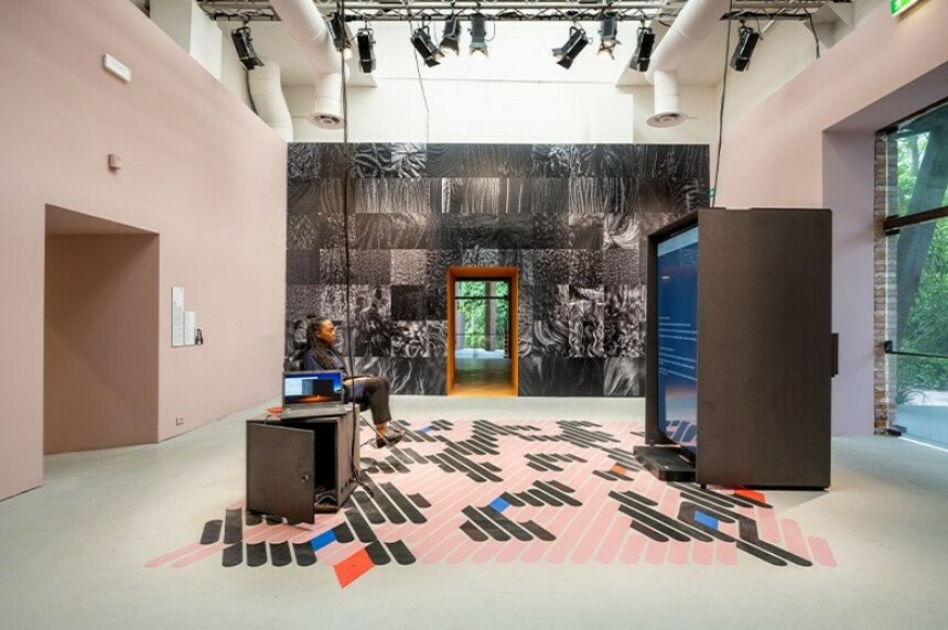 Felecia Davis sits in a hair salon chair in her display at the Venice Biennale.