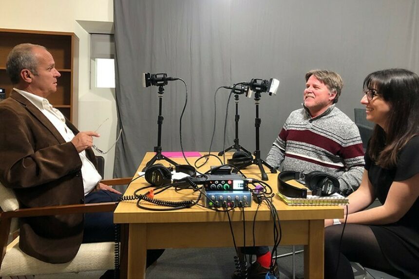 Keith Bowers, left, talks with Andy Cole and Kendall Mainzer, at. right.