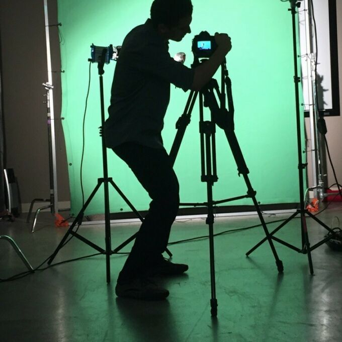 Silhouette of Caleb Yoder shooting video for DreamWorks.