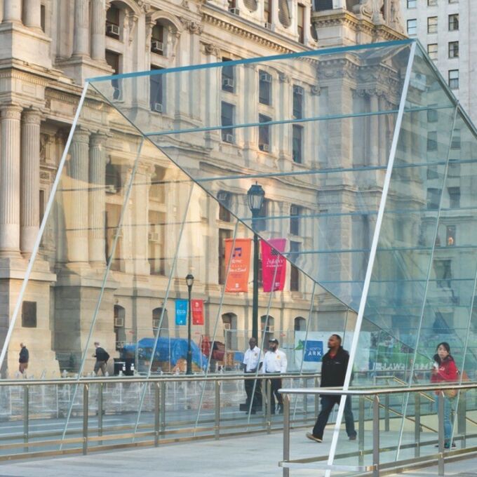 Cityscape featuring architectural glass structure designed by Marilia Rodrigues.