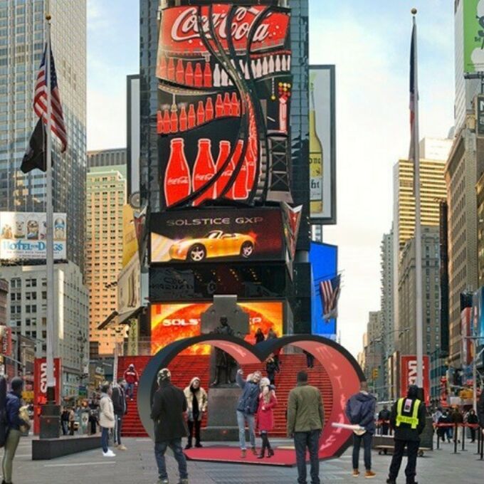 Pedestrians engaging with ‘The Ambiguous Heart,’ Samantha Josephat’s heart-shaped pavilion, featured in the 2019 Times Square Valentine heart design competition.