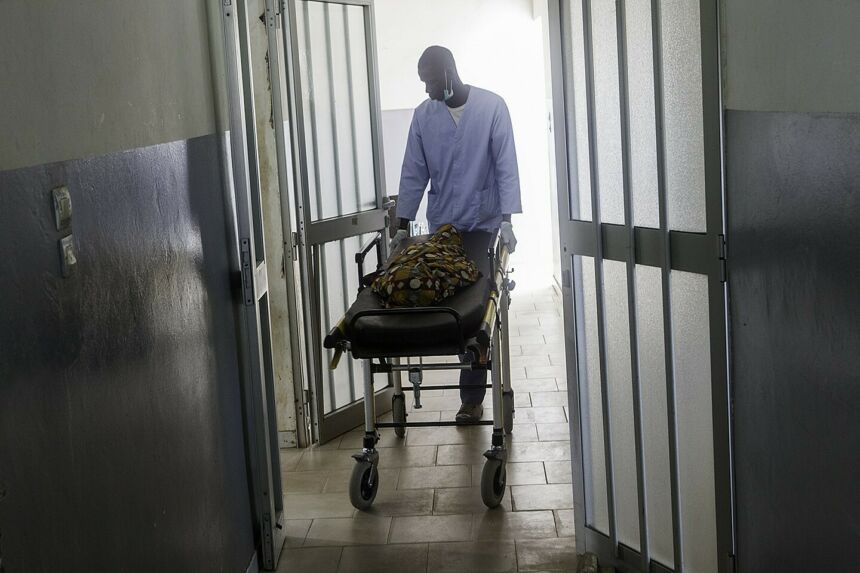 An emergency medical technician wheels out the body of a six-year-old girl who died from unregulated type 1 diabetes.