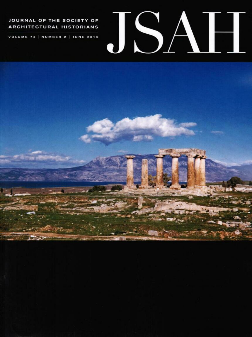 Black journal cover featuring photo of ruins with a mountainous landscape in the background, with cumulus clouds hovering in the blue sky