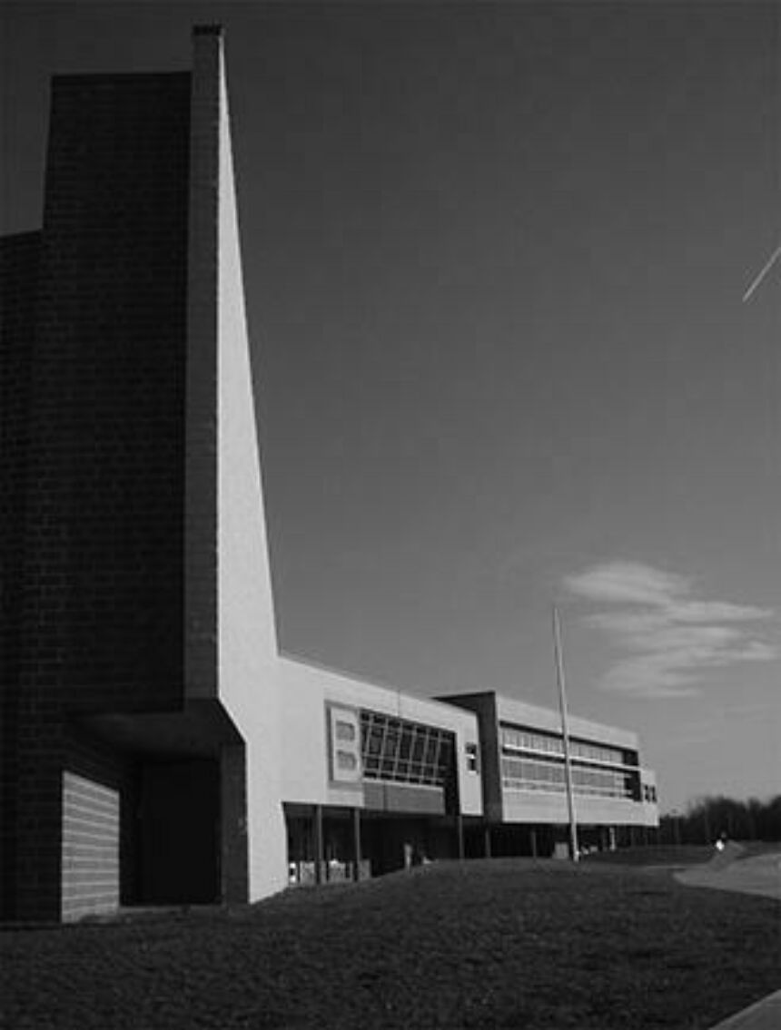 Exterior black and white shot of a modern high school.